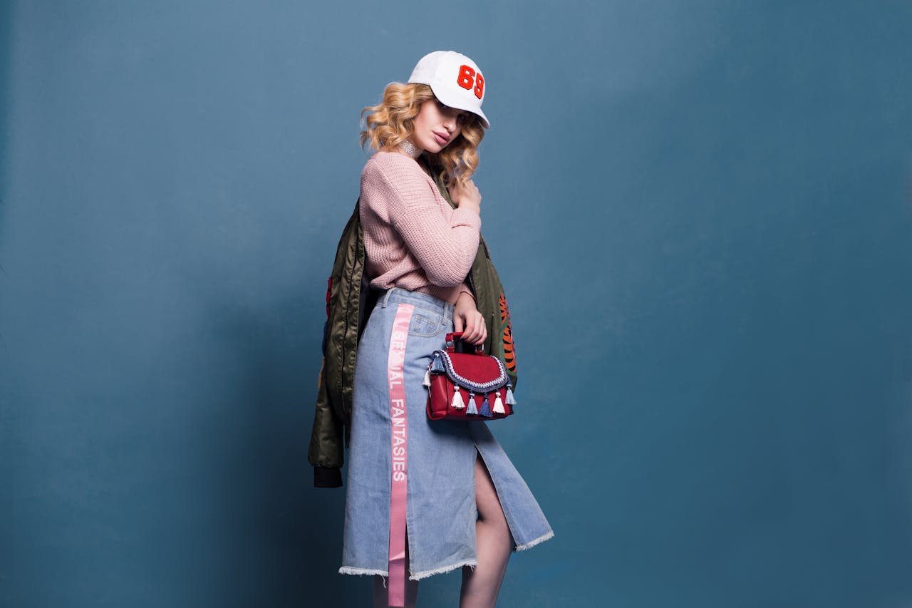 our-services-2 Trendy fashion model poses in a stylish studio setting, showcasing a chic outfit with accessories.